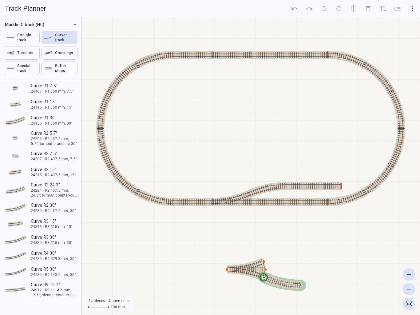 Dragging a curve onto a three-way turnout: the curve turns to match the open end and shows green before it is dropped